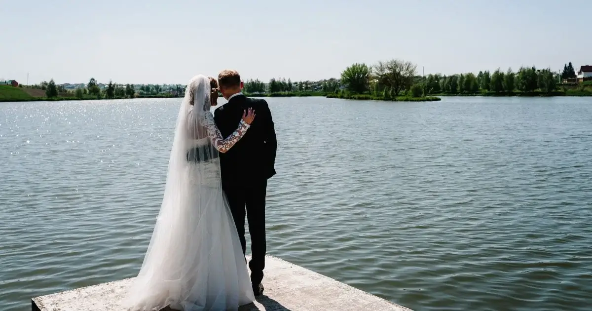 Bride and groom overlooking waterfront wedding venue